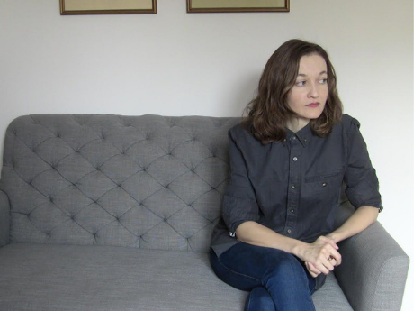 Jana Prikryl sitting on a gray couch