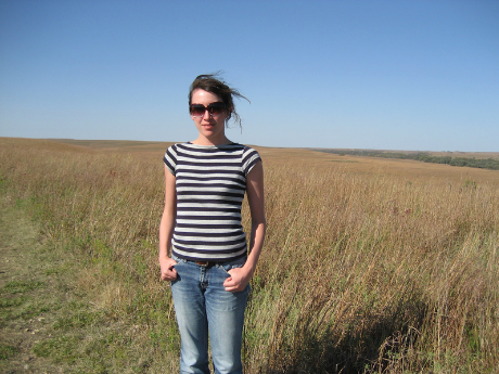Megan Kaminski standing before a field