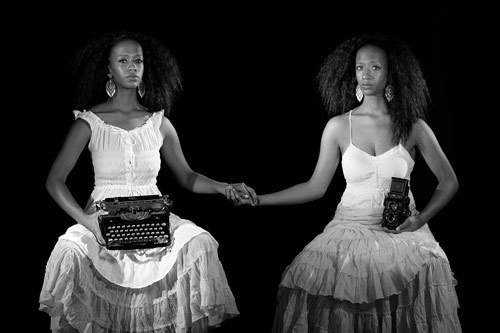 Two Elizas by Rachel Eliza Griffiths. A black and white photo of Rachel Eliza Griffith doubled, holding her own hand. One holds a camera, the other a typewriter.